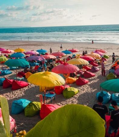 Colourful beach umbrellas with view of Double Six Beach, Seminyak, Bali, Indonesia