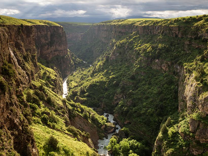 Admire the natural beauty of the Aksu river as it flows between endless mountains