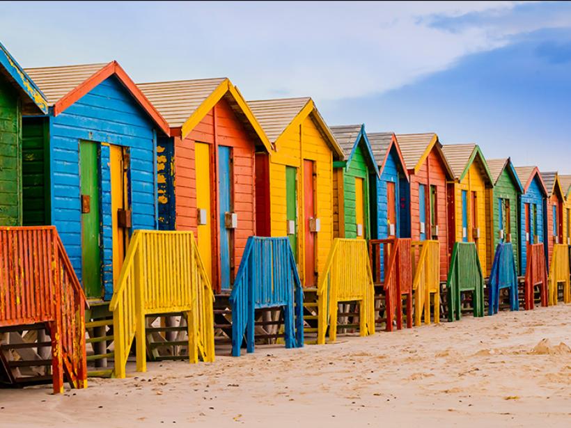 Hit the beach in Cape Town, stopping to change in a colourful bathing hut