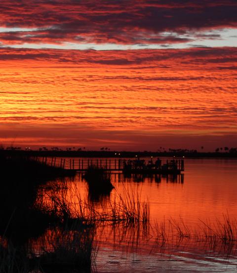 Sunset over river at wildlife reserve