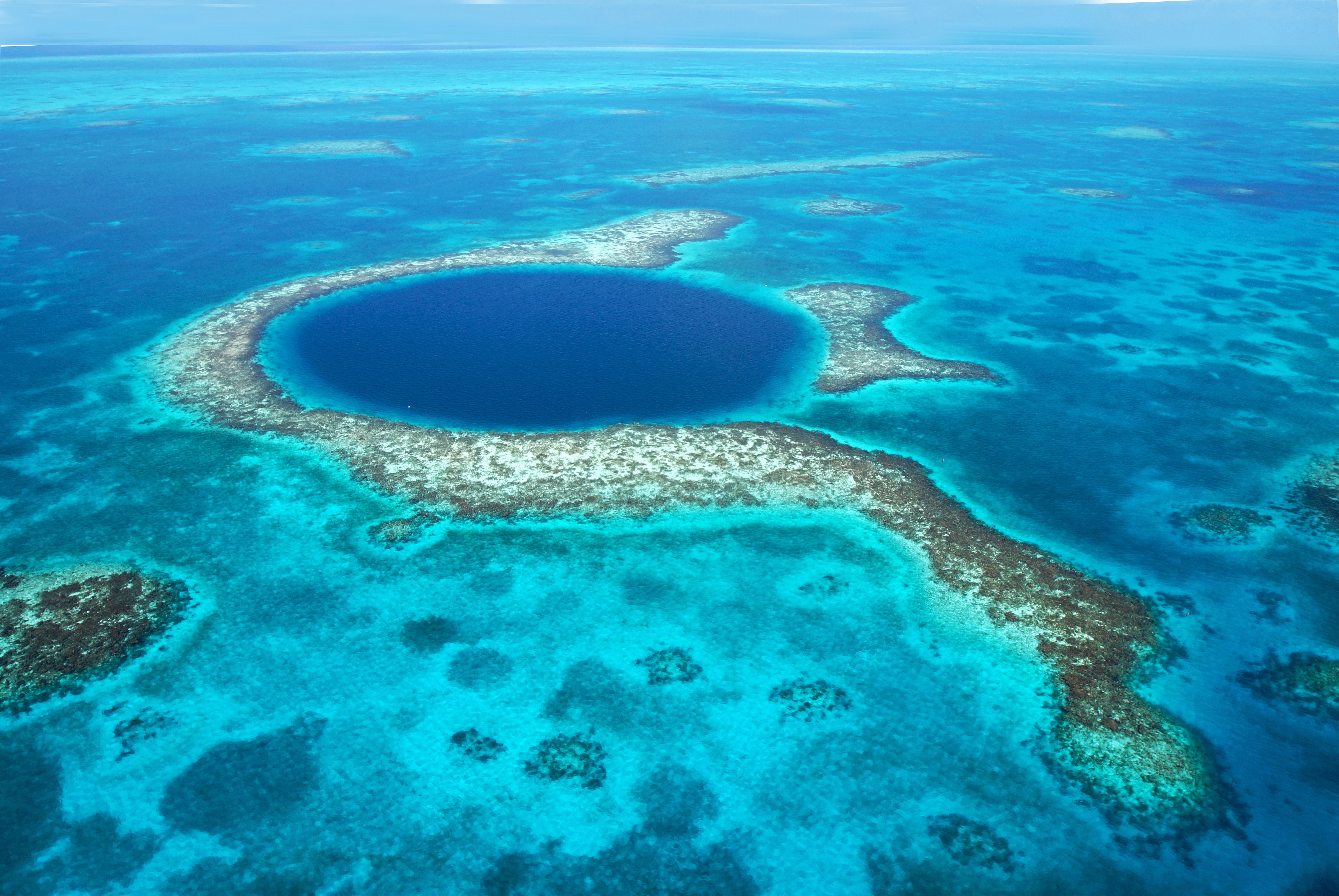 Great Blue Hole is a natural sinkhole off the coast of Belize that measures roughly 1,000 feet across and 400 feet deep