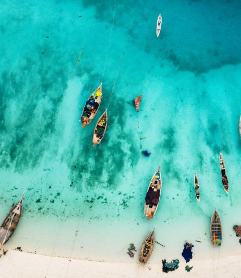 Aerial photos of boats and stunning blue waters of beach