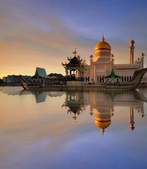 Sunset view of Sultan Omar Ali Saifudding Mosque, Bandar Seri Begawan, Brunei, Southeast Asia with reflection in water