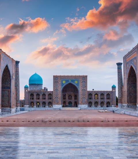 Samarkand Registan Square with Sher-Dor, Ulugh Beg and Tilya-Kori Madrasahs under colorful moody sunset twilight cloudscape