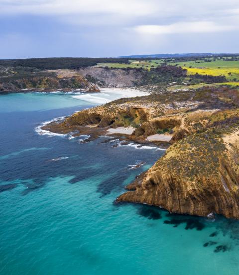 The dramatic rocky coastline of bright blue waters