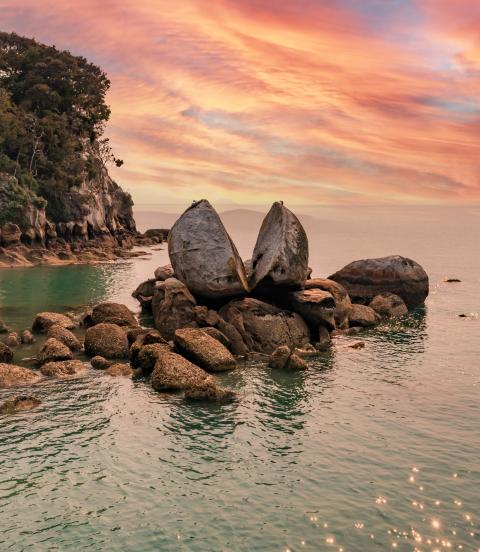 Famous rock and tourist site in national park with sunset in the background