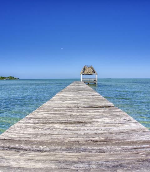 Pier over the blue sea on San Pedro Island in the Caribbean nation of Belize