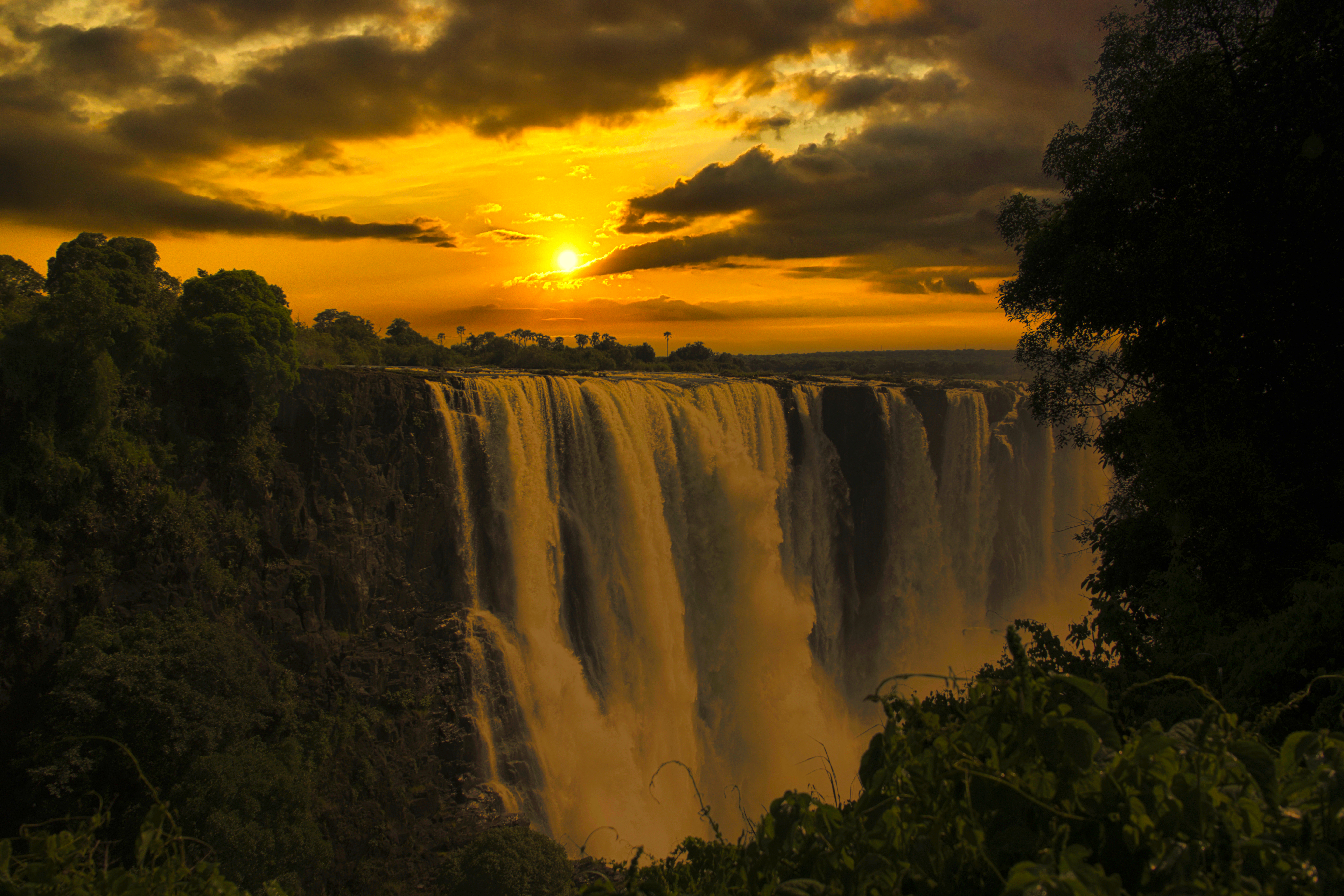 Sunrise breaks above Victoria Falls