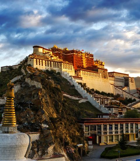 The red and white Potala Palace, is built on Red Mountain in the centre of Lhasa Valley and is the winter palace of the Dalai Lama