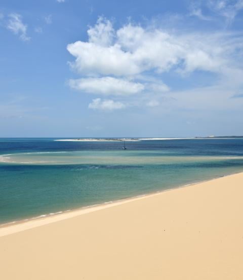 View from a sandune in the Bazaruto archipelago Mozambique with a luxury yacht lying at anchor below. 