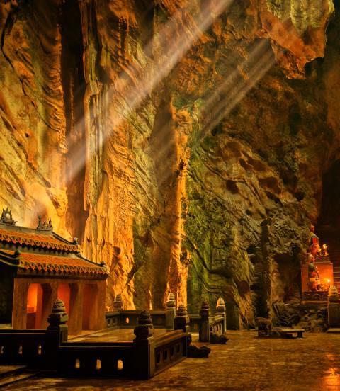 Dark cave with mystical Troglodyte temple, Huyen Khong grotto, Marble Mountains