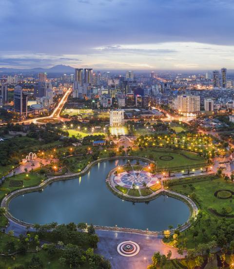 Hanoi skyline cityscape at twilight period, iwth Cau Giay park in foreground