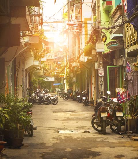 Motor bikes lined down narrow street of Ho Chi Minh city, Vietnam