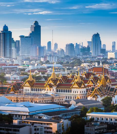 Sunrise of Bangkok tower skyline with The Grand Palace in foreground