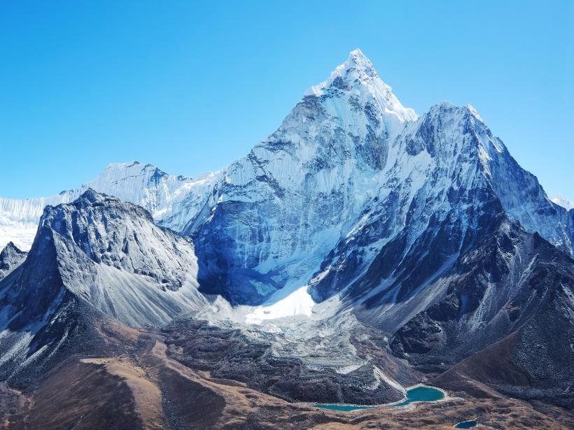 overwhelming mountain peak of Everest against clear blue skies