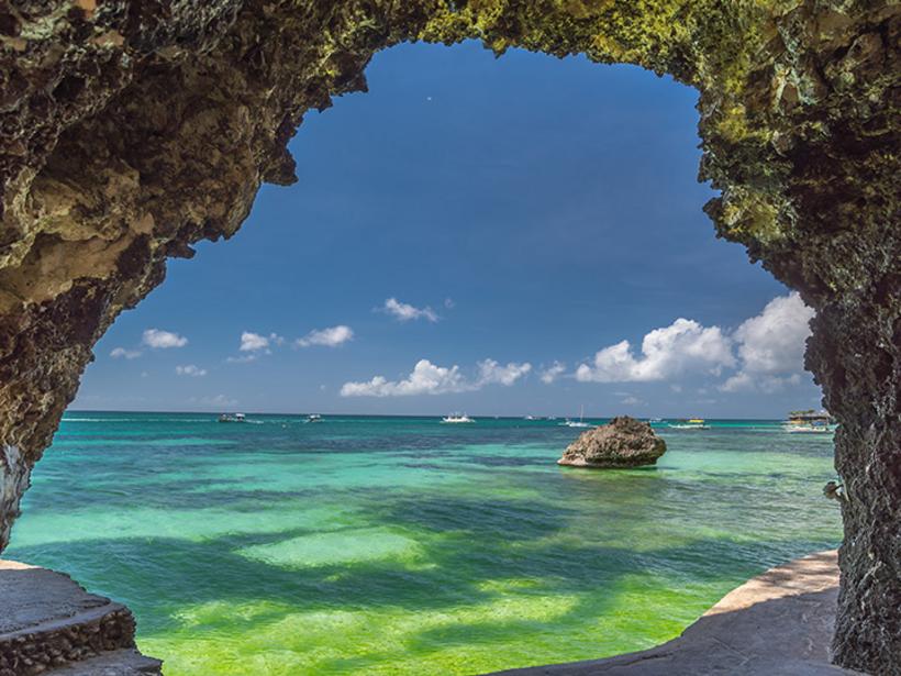 Explore the caves along White Beach, a popular spot in Boracay for its crystal waters and light sands