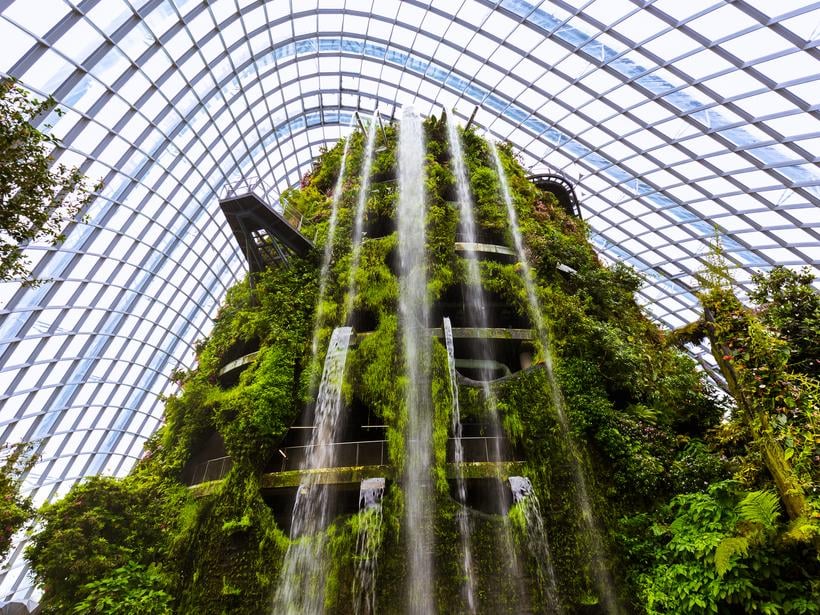 towering waterfalls cascading down an indoor structure of Cloud Forest Dome in Singapore's Gardens by the Bay